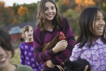 Group of four children holding chickens — Stock Photo
