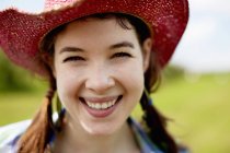 Woman in a pink straw hat — Stock Photo