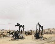 Oil rigs and wells — Stock Photo