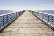 Long pier with railings — Stock Photo