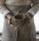 Mulher segurando ninho de pássaro — Fotografia de Stock