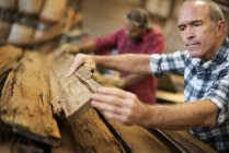 Men working reclaimed lumber workshop — Stock Photo