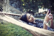 Woman lying in a large hammock — Stock Photo