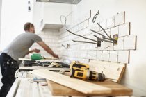 Man working in a new kitchen — Stock Photo