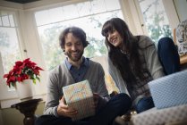 Couple exchanging wrapped presents. — Stock Photo