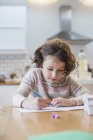 Girl writing card or letter — Stock Photo