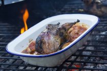 Game bird in a pan braising with vegetables. — Stock Photo