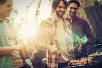 Friends at a summer evening barbeque. — Stock Photo