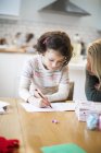 Mother and girl drawing letter to Santa — Stock Photo