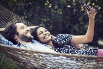 Couple lying in a large hammock — Stock Photo