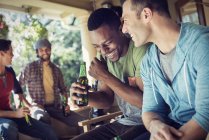 Men at a house party. — Stock Photo