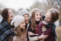 Girls in warm shawls and woolly hats — Stock Photo