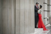Couple embracing on the steps of a building. — Stock Photo