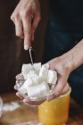 Person using a knife to dice lard — Stock Photo
