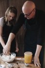 Man and young girl mixing ingredients — Stock Photo