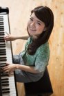 Woman playing on a grand piano — Stock Photo
