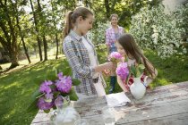 People gathering flowers and arranging together — Stock Photo