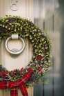 Christmas wreath on the front door — Stock Photo