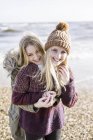 Girls on beach in winter time — Stock Photo