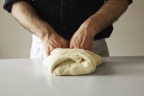 Baker kneading bread dough. — Stock Photo