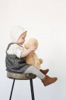 Fille assise sur grand tabouret — Photo de stock