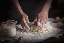 Woman kneading dough for biscuits — Stock Photo