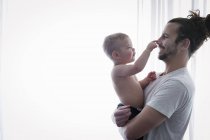 Man holding a small child — Stock Photo
