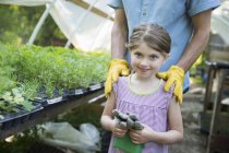 Man and child with gardening gloves — Stock Photo
