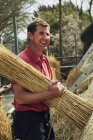 Thatcher carrying yelm of straw. — Stock Photo