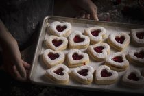 Baking tray with heart shaped biscuits — Stock Photo