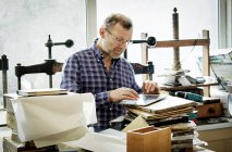 Man in a bookbinding workshop. — Stock Photo