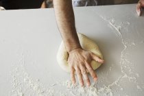 Bäcker formt Teig zu einer Kugel. — Stockfoto