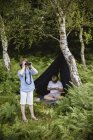 Dos chicos acampando en el bosque - foto de stock