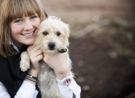 Donna abbraccio peloso terrier cucciolo — Foto stock