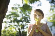 Young girl blowing bubbles — Stock Photo