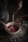 Женщина добавляет сахар в свежую малину — стоковое фото
