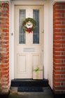 Christmas wreath on the front door — Stock Photo