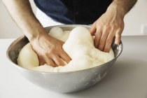 Baker kneading bread dough — Stock Photo