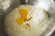 Bread dough in metal mixing bowl — Stock Photo
