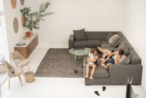 Мама с детьми веселится на диване — стоковое фото
