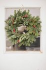 Christmas wreath on a door. — Stock Photo