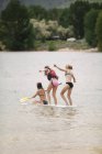 Girls on paddle board — Stock Photo
