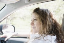 Woman in a car on a road trip — Stock Photo
