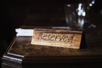 Reserved sign on polished table — Stock Photo