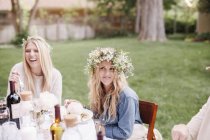 Women with flower wreaths — Stock Photo