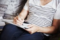 Man using pen and drawing sketches — Stock Photo