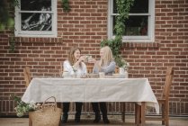 Женщины возле дома, обедающие . — стоковое фото