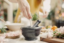 Hand adding ingredients — Stock Photo