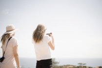 Mujer y adolescente tomando fotos - foto de stock