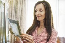 Senior woman looking at a picture. — Stock Photo